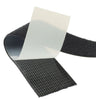 Black adhesive loop tape with acrylic adhesive liner peeling away, showing the self-adhesive backing